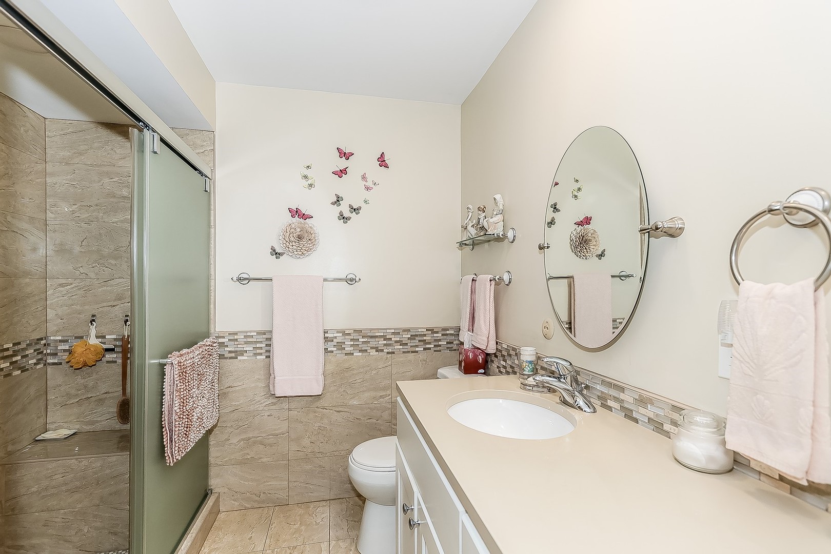 1175 Lake Cook Road, Unit 409 Northbrook, IL 60062 - Photo 17 of 27 a bathroom with a sink mirror and toilet