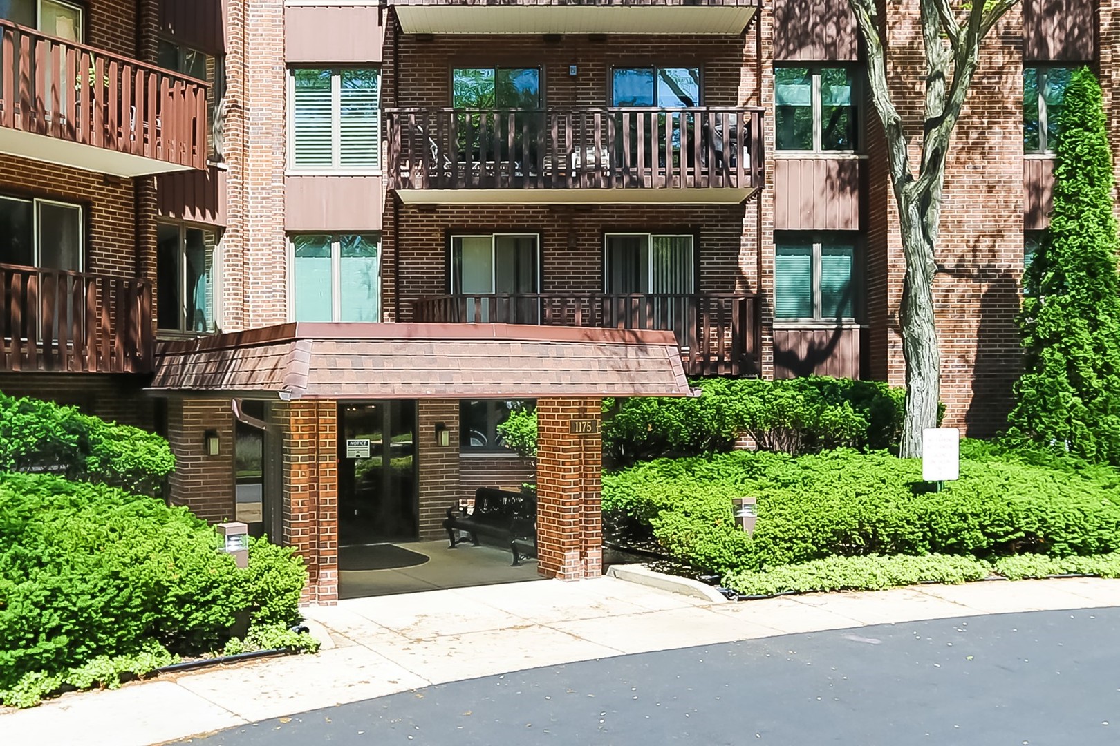 1175 Lake Cook Road, Unit 409 Northbrook, IL 60062 - Photo 24 of 27 a view of a brick house with large windows and plants