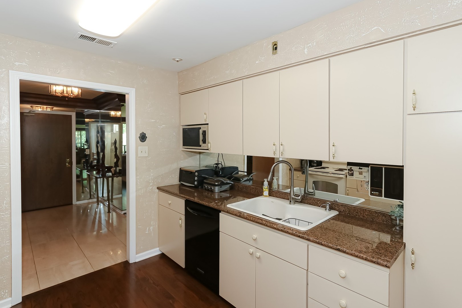 1175 Lake Cook Road, Unit 409 Northbrook, IL 60062 - Photo 7 of 27 a kitchen with a sink appliances and cabinets