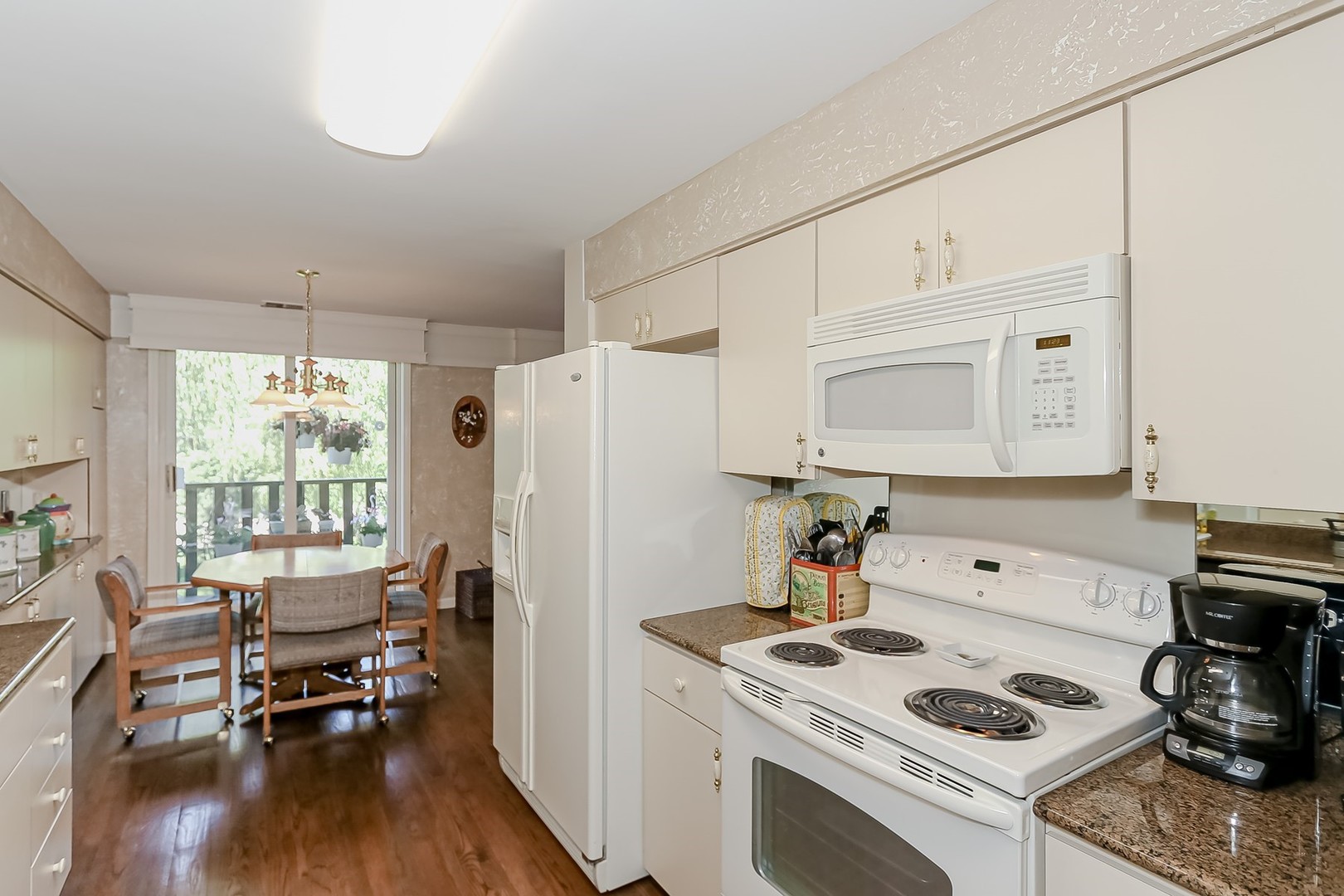 1175 Lake Cook Road, Unit 409 Northbrook, IL 60062 - Photo 8 of 27 a kitchen with a stove a refrigerator and wooden floor