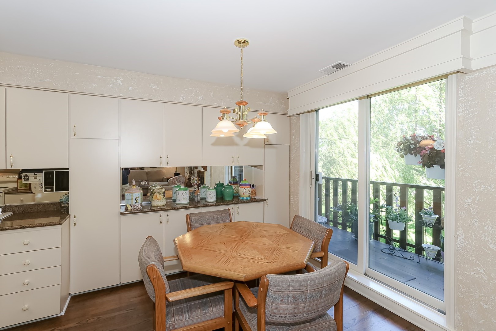 1175 Lake Cook Road, Unit 409 Northbrook, IL 60062 - Photo 10 of 27 a dining room with furniture a chandelier and wooden floor