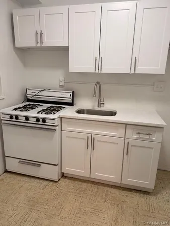 a kitchen with white cabinets