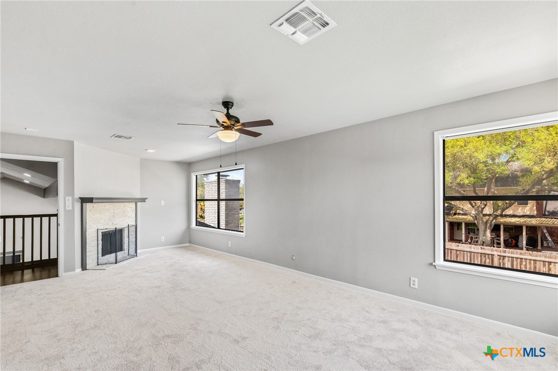 116 Newport Drive Victoria, TX 77904 - Photo 14 of 25 a view of an empty room with a window and fireplace