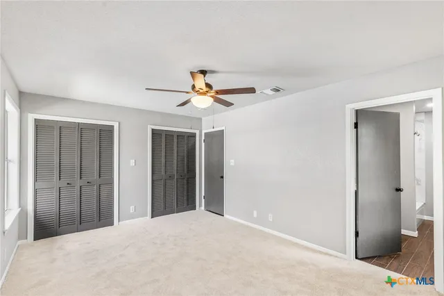 a view of a livingroom with a ceiling fan and entryway