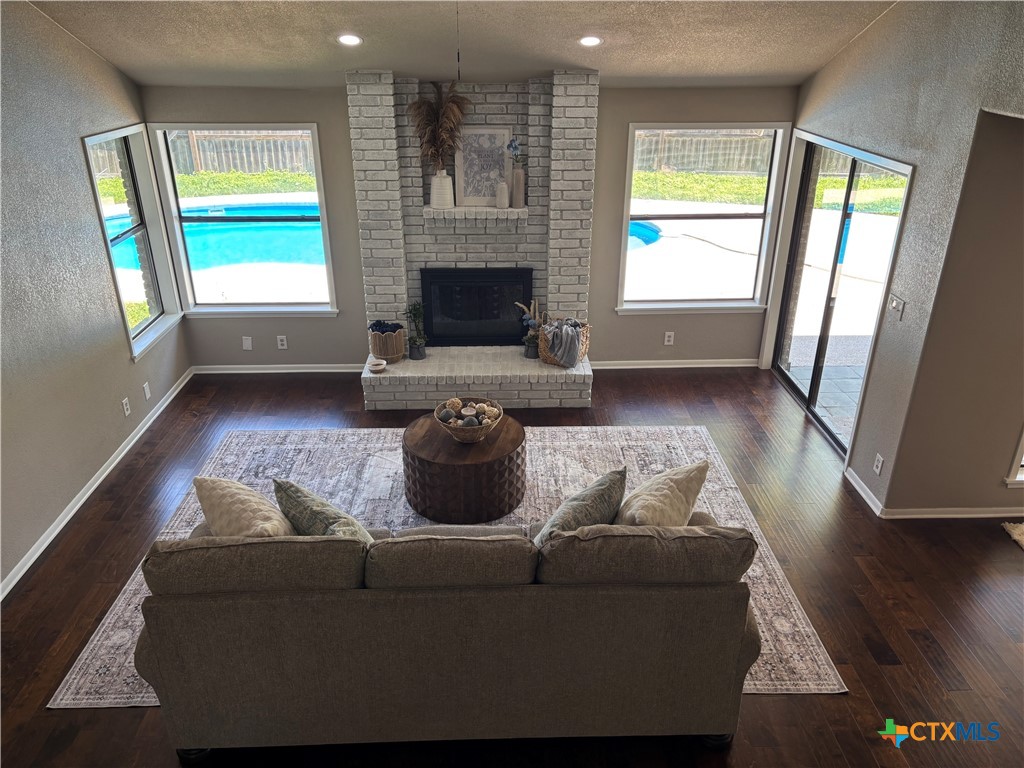 116 Newport Drive Victoria, TX 77904 - Photo 6 of 25 a living room with furniture and a fireplace