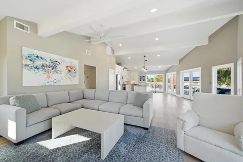 a living room with furniture and a painting