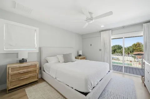 a bedroom with a bed tv and a window