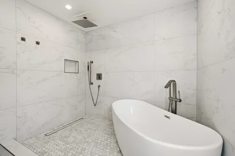 a bathroom with a bathtub and a shower