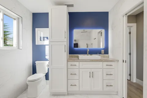 a spacious bathroom with a bathtub sink and mirror