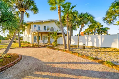 a view of a house with palm trees