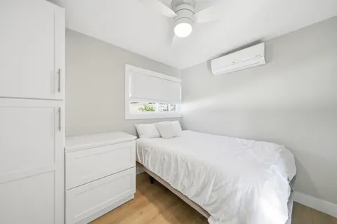 a living room with a flat screen tv and floor to ceiling window