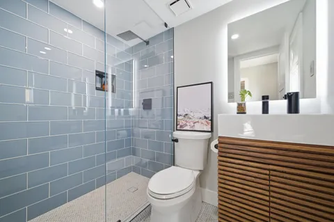 a living room with a flat screen tv and floor to ceiling window