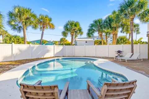 a swimming pool with outdoor seating and yard