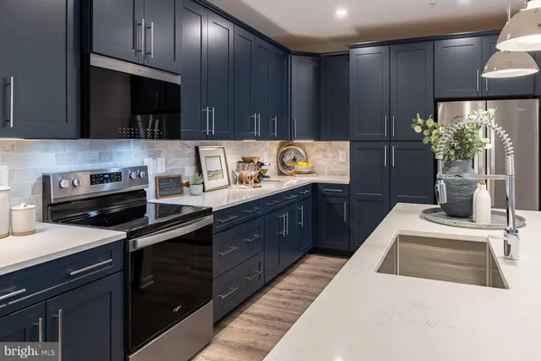 a kitchen with a sink a stove and cabinets
