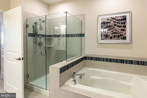 a bathroom with a bathtub and shower