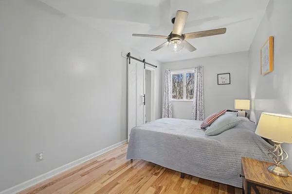 a large bedroom with a large bed and a large window