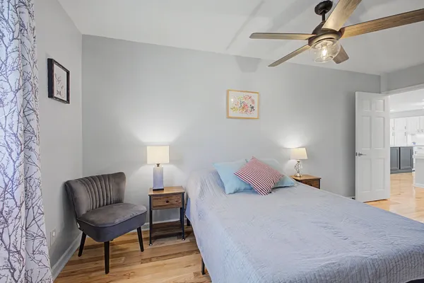 a bedroom with a bed and a chandelier