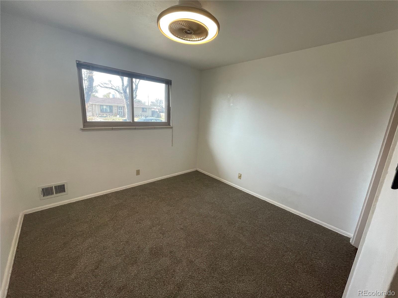 3086 Victor Street Aurora, CO 80011 - Photo 13 of 30 an empty room with windows