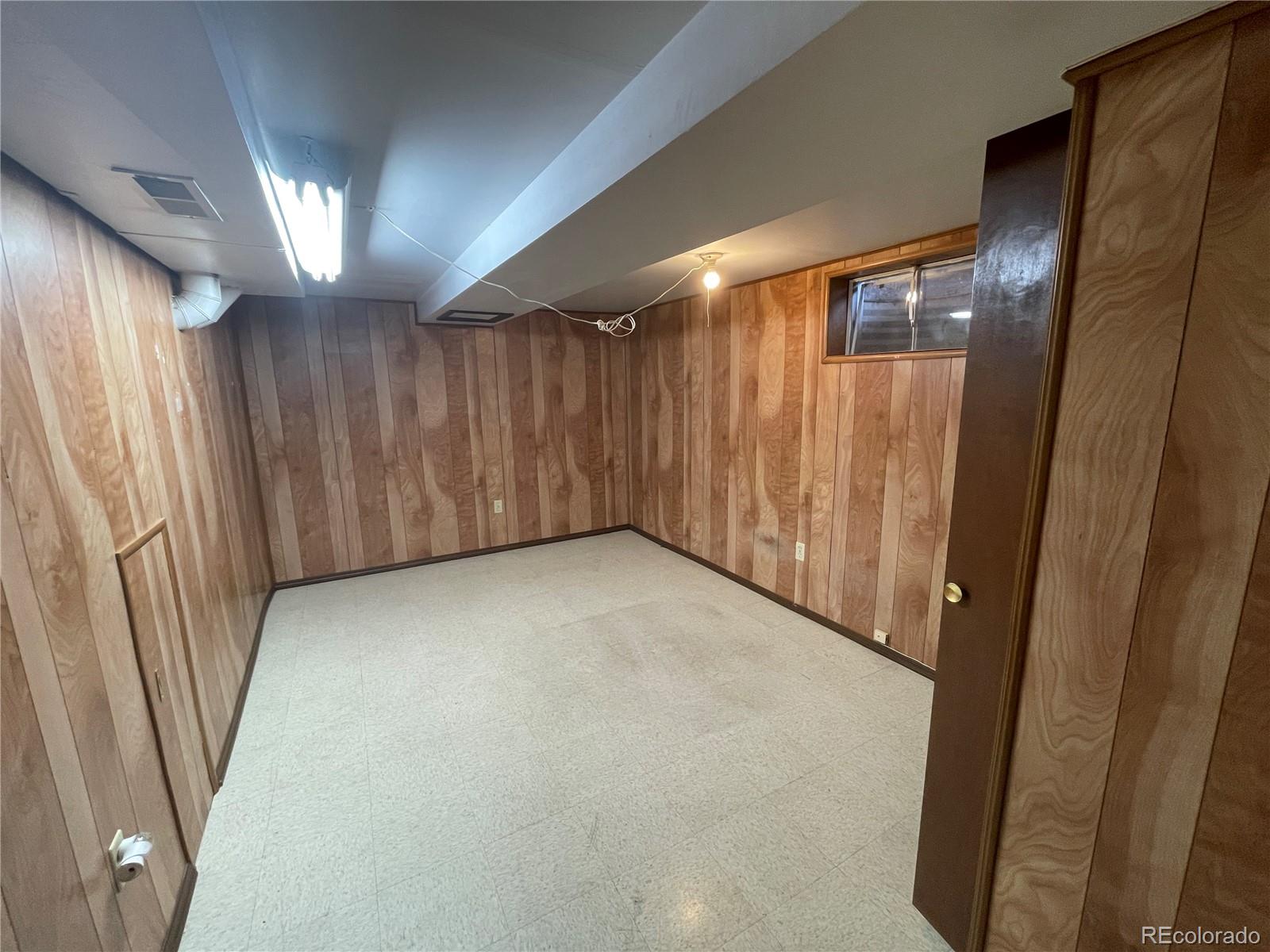 3086 Victor Street Aurora, CO 80011 - Photo 22 of 30 a view of an empty room with wooden floor and a window
