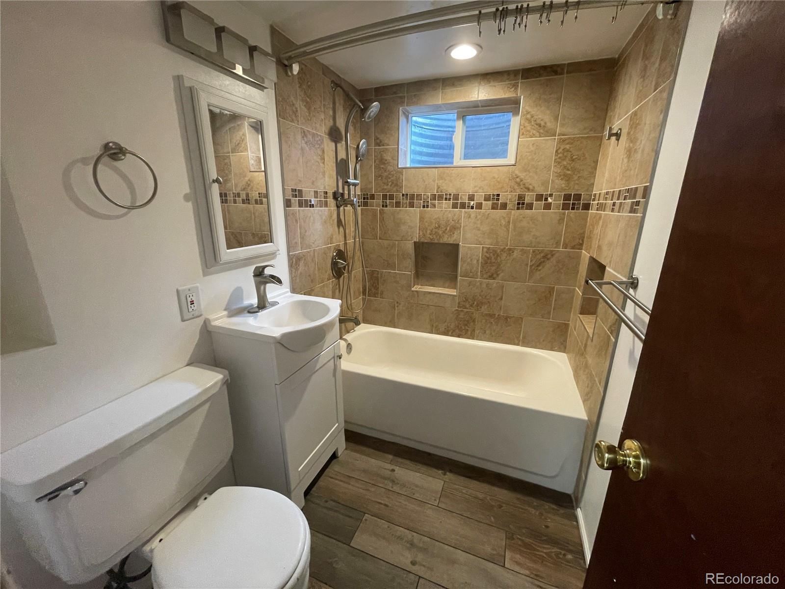 3086 Victor Street Aurora, CO 80011 - Photo 26 of 30 a bathroom with a sink toilet and shower