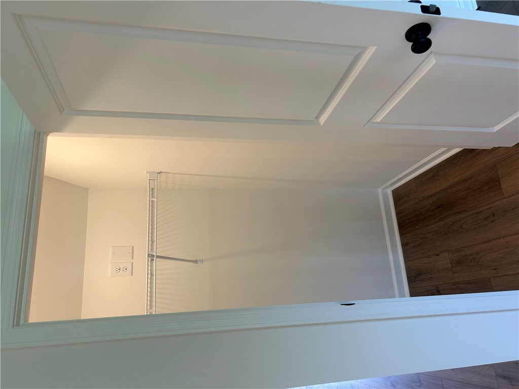 202 Bellflower Lane Pendleton, SC 29670 - Photo 11 of 27 A well-organized walk-in closet with ample storage solutions and warm wood flooring.