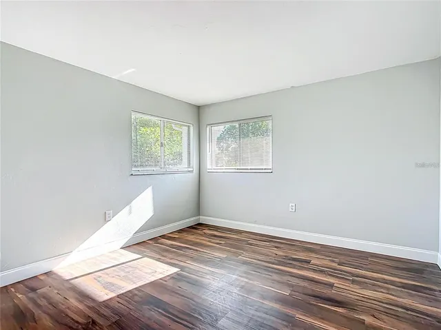 a view of a room with wooden floor and window