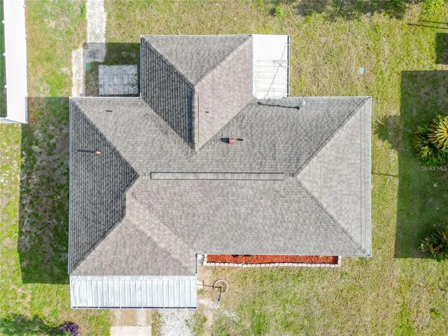 an aerial view of a house with swimming pool