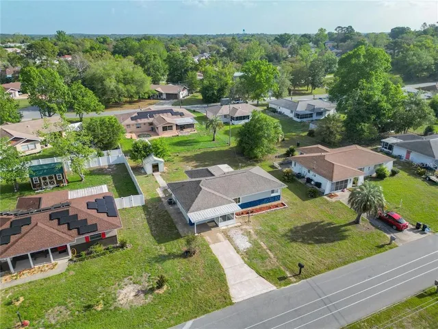 an aerial view of a house with garden space and street view