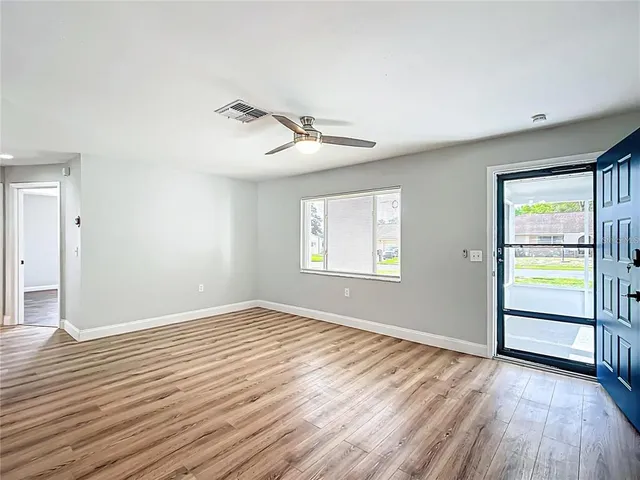 wooden floor in an empty room with a window