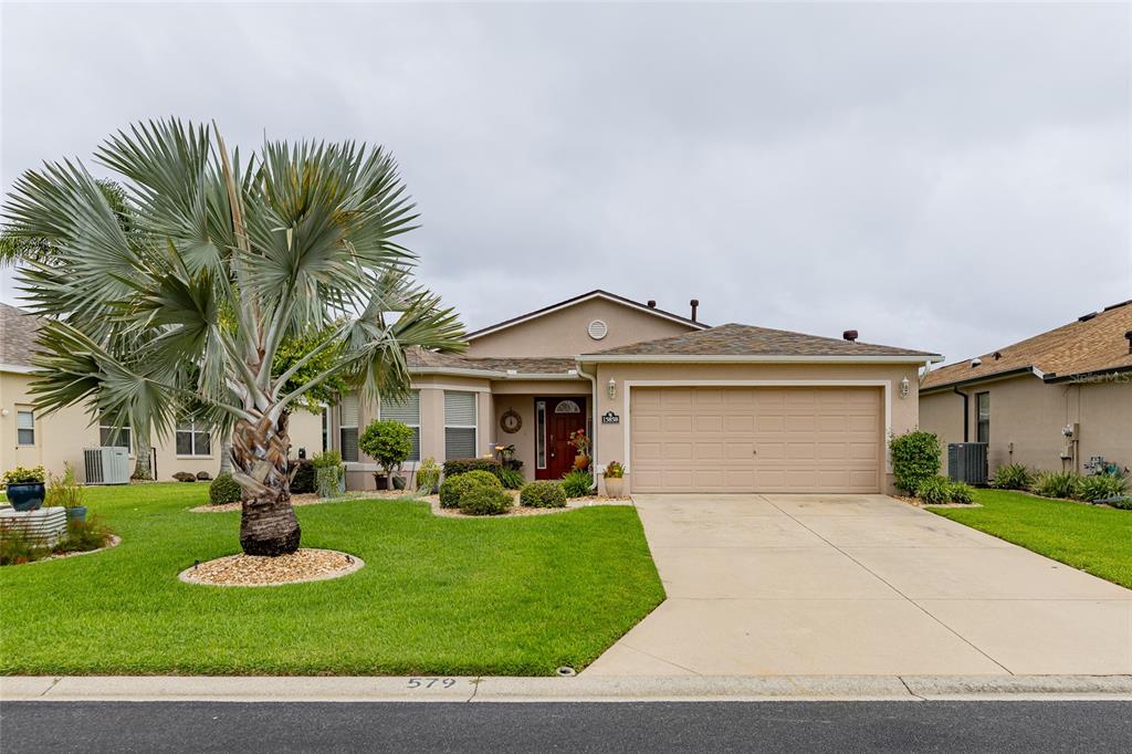 15858 Southwest 11th Court Road Ocala, FL 34473 - Photo 1 of 59 a front view of a house with a yard and garage