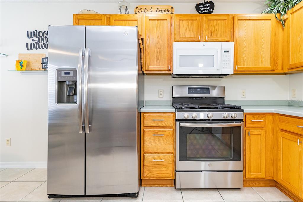 15858 Southwest 11th Court Road Ocala, FL 34473 - Photo 15 of 59 a kitchen with stainless steel appliances granite countertop a refrigerator and a stove