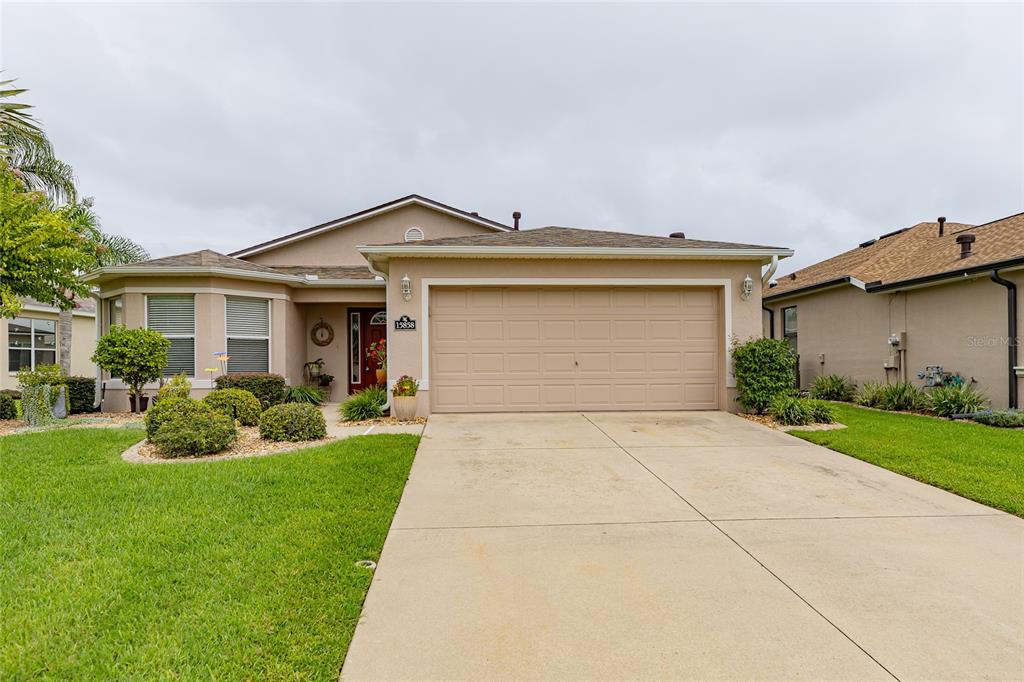 15858 Southwest 11th Court Road Ocala, FL 34473 - Photo 2 of 59 a front view of house with yard and green space