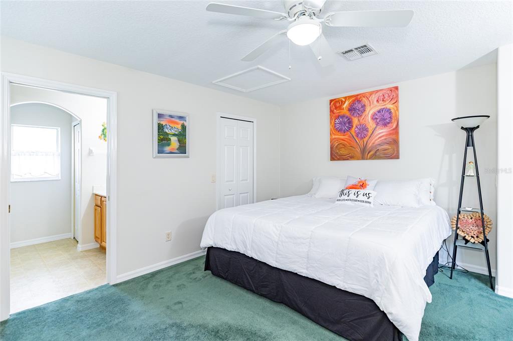 15858 Southwest 11th Court Road Ocala, FL 34473 - Photo 21 of 59 a bedroom with a bed and a chandelier