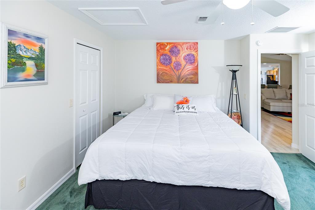 15858 Southwest 11th Court Road Ocala, FL 34473 - Photo 22 of 59 a large bed sitting in a bedroom and painting on the wall