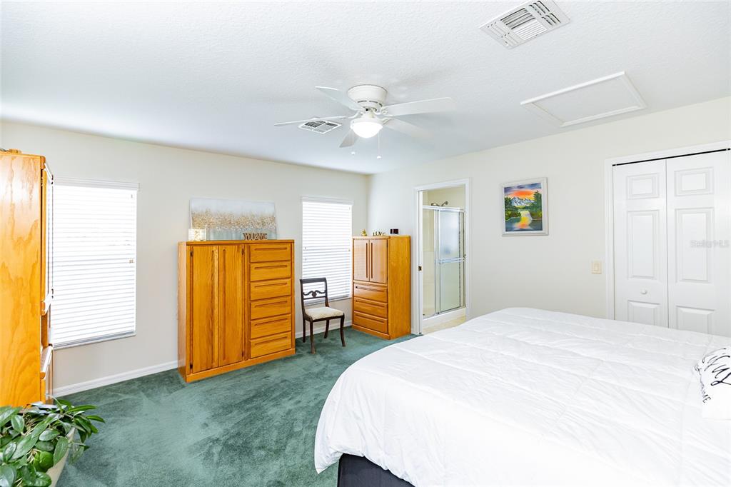 15858 Southwest 11th Court Road Ocala, FL 34473 - Photo 23 of 59 a bedroom with a bed and a chandelier