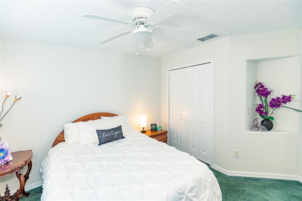 15858 Southwest 11th Court Road Ocala, FL 34473 - Photo 29 of 59 a bedroom with a bed and a chandelier