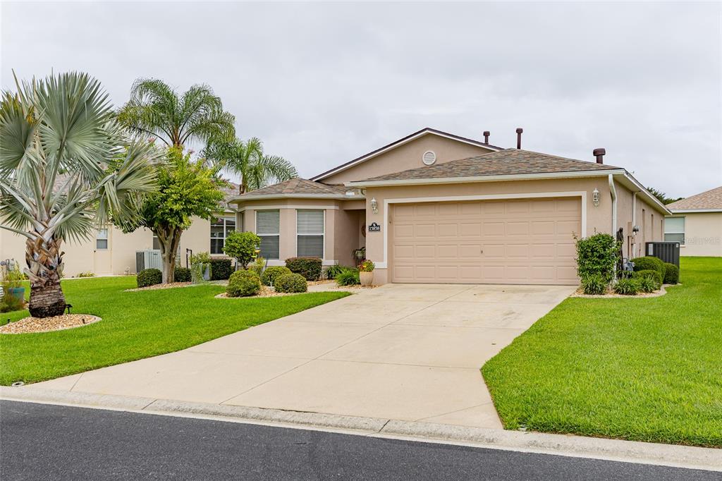 15858 Southwest 11th Court Road Ocala, FL 34473 - Photo 3 of 59 a front view of a house with a yard and garage