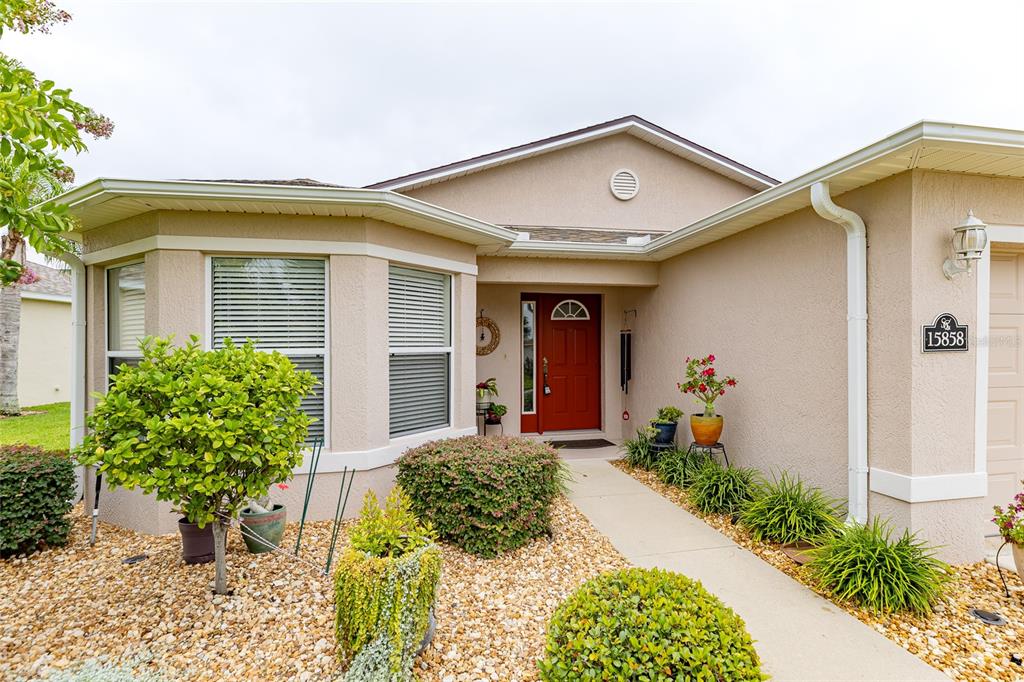 15858 Southwest 11th Court Road Ocala, FL 34473 - Photo 4 of 59 a front view of a house with garden