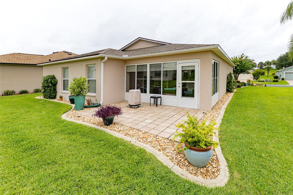 15858 Southwest 11th Court Road Ocala, FL 34473 - Photo 42 of 59 a front view of a house with a yard outdoor seating and garage