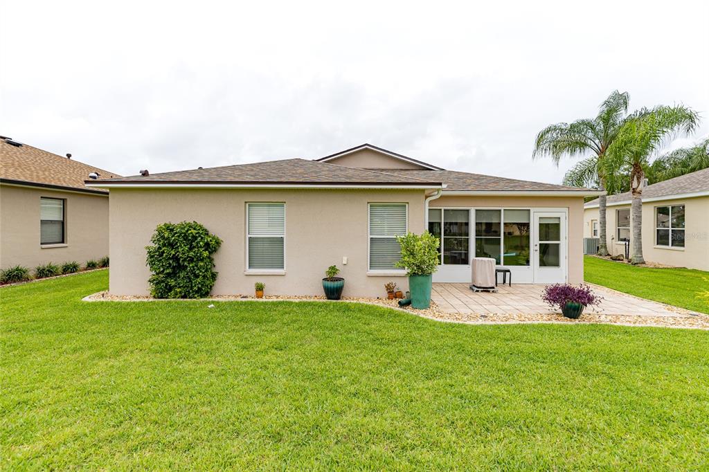 15858 Southwest 11th Court Road Ocala, FL 34473 - Photo 43 of 59 a front view of a house with a yard and garage
