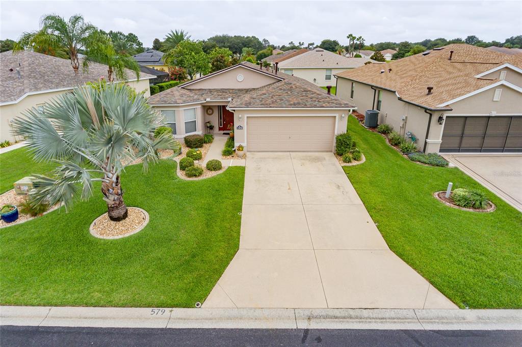 15858 Southwest 11th Court Road Ocala, FL 34473 - Photo 58 of 59 a view of a white house with a yard plants and large tree
