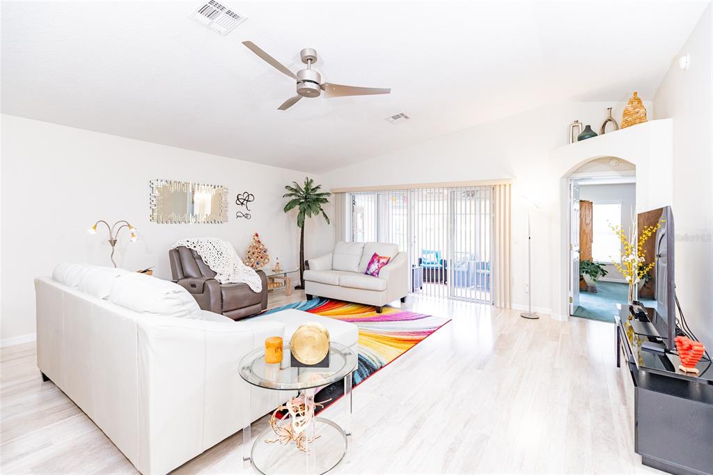 15858 Southwest 11th Court Road Ocala, FL 34473 - Photo 8 of 59 a living room with furniture a flat screen tv and a table