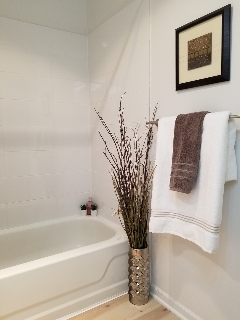 725 West Huntington Commons Road, Unit 416 Mount Prospect, IL 60056 - Photo 11 of 17 a white bath tub sitting next to a white sink