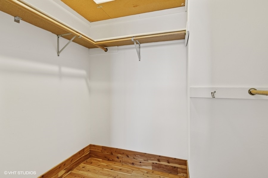 725 West Huntington Commons Road, Unit 416 Mount Prospect, IL 60056 - Photo 9 of 17 a view of a room with racks on the wall