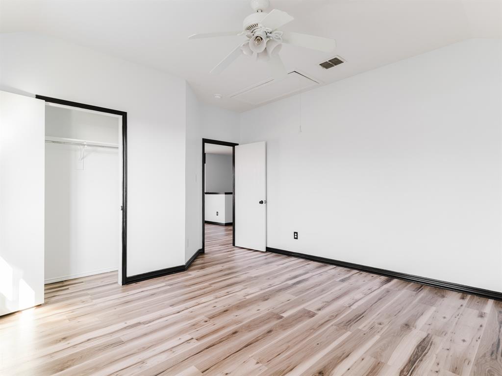 1733 Elm Street Anna, TX 75409 - Photo 23 of 25 Unfurnished bedroom with attic access, light wood-style flooring, ceiling fan, lofted ceiling, and a closet