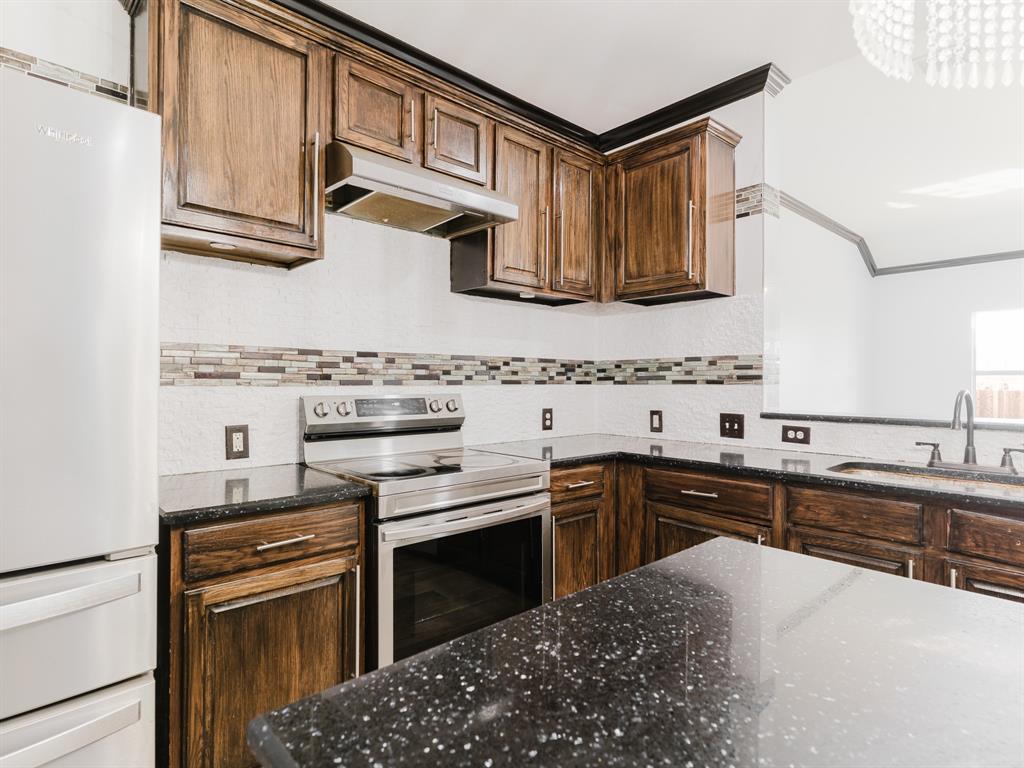 1733 Elm Street Anna, TX 75409 - Photo 4 of 25 a kitchen with stainless steel appliances granite countertop a stove and a sink