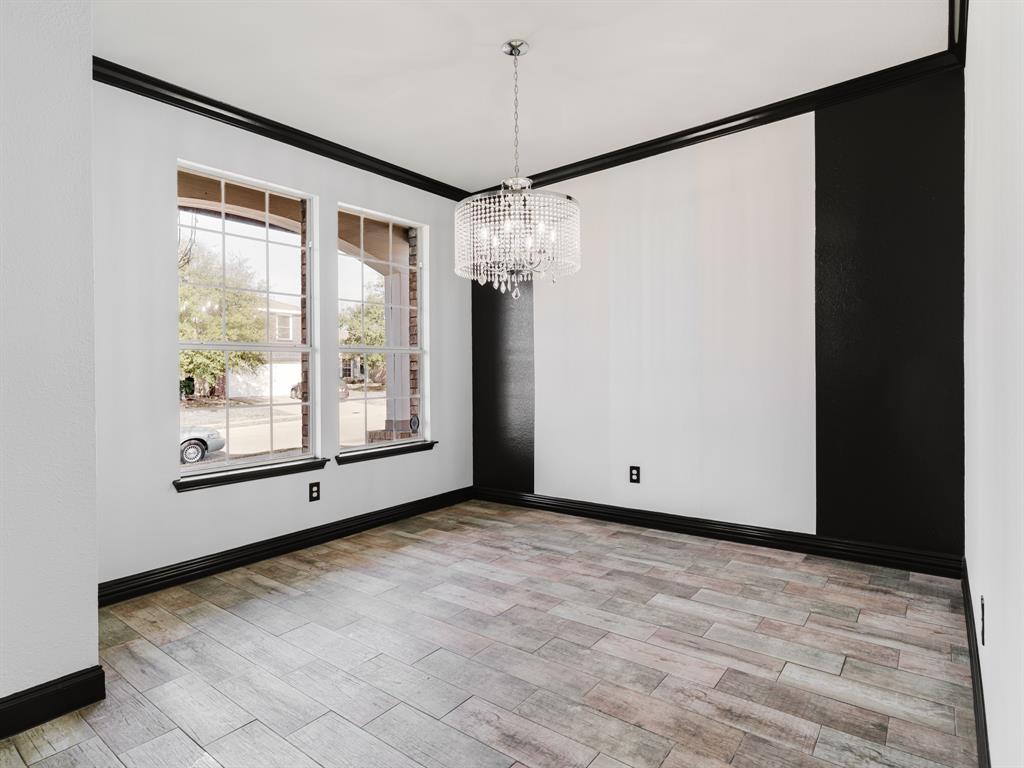 1733 Elm Street Anna, TX 75409 - Photo 6 of 25 Empty room with ornamental molding, a chandelier, and light wood finished floors