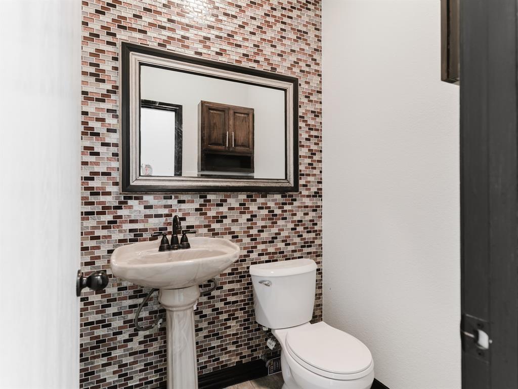 1733 Elm Street Anna, TX 75409 - Photo 9 of 25 Half bath featuring decorative backsplash and tile walls