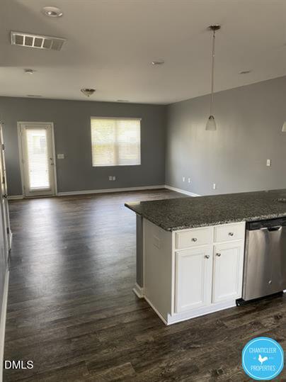 8960 Commons Townes Drive Raleigh, NC 27616 - Photo 3 of 13 a kitchen with granite countertop a stove a sink and a microwave