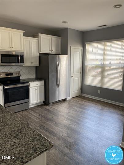 8960 Commons Townes Drive Raleigh, NC 27616 - Photo 5 of 13 a kitchen with stainless steel appliances granite countertop a refrigerator a stove a sink and a microwave